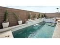 Inviting rectangular pool with spa and a brick wall backdrop at 7777 Tempest Sol Ave, Las Vegas, NV 89113