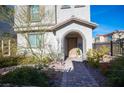 Front entrance with a paved pathway and landscaping at 8034 Mercury Skye St, Las Vegas, NV 89166