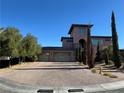 Mediterranean style home with a three-car garage and paved driveway at 8490 Via De Bellasidra Ct, Las Vegas, NV 89123