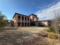 Two story home with arched entryway and gravel driveway at 8490 Via De Bellasidra Ct, Las Vegas, NV 89123