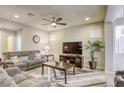 Living room with gray sectional sofa and large TV at 9240 Long Grove Ave, Las Vegas, NV 89149