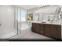 Elegant bathroom with double vanity, soaking tub, and walk-in shower at 9656 Biedler Ct # Lot 7, Las Vegas, NV 89178