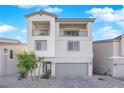 Two-story house with gray exterior, two-car garage, and balcony at 10375 Rose Palisade St, Las Vegas, NV 89141