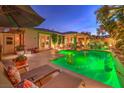 Stunning pool and spa with inviting patio furniture and outdoor lighting at 10414 Hemingway Ct, Las Vegas, NV 89149