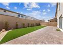 Landscaped backyard with artificial turf and paver patio at 1070 Kelly Brook Ln, Henderson, NV 89011