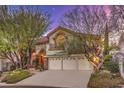 Two-story house with a three-car garage and manicured landscaping at 1705 Corta Bella Dr, Las Vegas, NV 89134