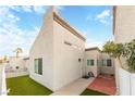 Exterior view of a light-colored stucco house with a small front yard and walkway at 2254 High Dunes Ln, Laughlin, NV 89029