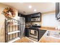 View of a kitchen with dark cabinets, stainless steel appliances, and granite countertops at 2254 High Dunes Ln, Laughlin, NV 89029