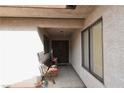 Covered entryway with tiled flooring and a wooden bench at 2816 Mohawk St, Las Vegas, NV 89146