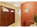 Interior entryway with wood double doors and terracotta-colored walls at 2816 Mohawk St, Las Vegas, NV 89146