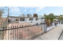 Front view of a remodeled home with a decorative iron gate at 2824 Bassler St, North Las Vegas, NV 89030