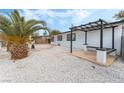 Relaxing patio area with pergola and built-in bench seating at 2824 Bassler St, North Las Vegas, NV 89030