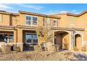 Two-story townhome with front patio, landscaping, and a walkway at 3296 Palindrome Ave, Henderson, NV 89044