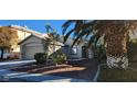 Front view of a single-story house with a two-car garage at 3330 Trotting Horse Rd, North Las Vegas, NV 89032