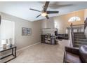 Open-concept living room with tile floors, vaulted ceilings, a cozy fireplace, and natural light at 433 Jubilation Dr, Las Vegas, NV 89145