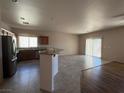 Open kitchen with island, granite countertops, and stainless steel appliances at 4419 S Glory Vine Ln, Pahrump, NV 89061