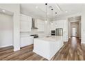 Modern kitchen featuring white cabinets, quartz countertops, and an island at 4973 Sandline Ct, Las Vegas, NV 89135