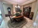 Formal dining room with a wood table, chairs, and a china cabinet at 5016 Wayfaring Tree Ave, Las Vegas, NV 89131