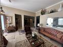 Spacious living room with leather sofas, a coffee table, and views into adjacent rooms at 5016 Wayfaring Tree Ave, Las Vegas, NV 89131