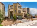 Two-story modern home with green garage door and light brown exterior at 6075 Wyndham Estate Ave, Las Vegas, NV 89141