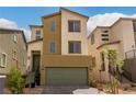 Two-story home with a green garage door and light brown and beige exterior at 6075 Wyndham Estate Ave, Las Vegas, NV 89141