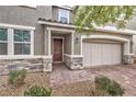 Inviting front entrance with stone accents and a double-door entry at 6403 Ava Ridge Ave, Las Vegas, NV 89141