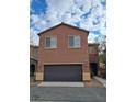 Two-story house with brown exterior and a two-car garage at 690 Calamus Palm Pl, Henderson, NV 89011