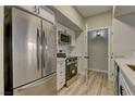 Modern kitchen with stainless steel appliances and white shaker cabinets at 6955 N Durango Dr # 1048, Las Vegas, NV 89149