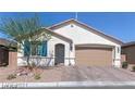 Single-story home with attached garage and desert landscaping at 7129 Flora Lam St, Las Vegas, NV 89166