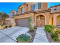 Two story house with a two car garage and landscaped front yard at 7683 Jasmine Falls Dr, Las Vegas, NV 89179