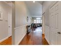 Hardwood floors, white wainscoting, and views of the living room at 7976 Sleeping Lily Dr, Las Vegas, NV 89178