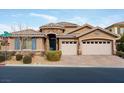 Single-story house with a three-car garage and landscaped front yard at 7976 Sleeping Lily Dr, Las Vegas, NV 89178