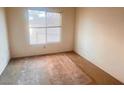 Bedroom featuring a window and showing worn carpet at 8070 W Russell Rd # 2068, Las Vegas, NV 89113