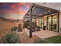 Relaxing patio with pergola, seating, and water feature at 816 Loch Katrine Ave, Henderson, NV 89012