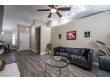 Living room features a gray sofa and glass coffee table at 8233 Ducharme Ave, Las Vegas, NV 89145