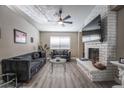 Living room with gray sofas, coffee table, and fireplace at 8233 Ducharme Ave, Las Vegas, NV 89145