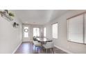 Bright dining area with wood floors and modern table at 8415 Quarentina Ave, Las Vegas, NV 89149