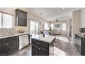 Modern kitchen with dark cabinets, island, and stainless steel appliances at 8415 Quarentina Ave, Las Vegas, NV 89149