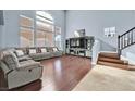 Living room with hardwood floors and large sectional sofa at 9225 Evergreen Canyon Dr, Las Vegas, NV 89134