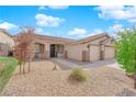 Charming single-story home features desert landscaping, a covered front porch and a security door at 1016 Pearl Peak St, Las Vegas, NV 89110