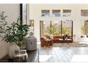 Bright living room showcasing large windows and comfortable modern furnishings at 11015 Sanctuary Cove Ct, Las Vegas, NV 89135