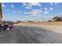 Large backyard with dirt and a trampoline. Some outdoor furniture is present at 4430 Deliza Ln, Pahrump, NV 89061