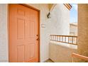 Orange front door with a small balcony at 4655 Gold Dust Ave # 210, Las Vegas, NV 89120