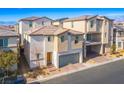 Attractive two-story home with a two-car garage; professionally landscaped yard at 6935 Magenta Moon St, North Las Vegas, NV 89086