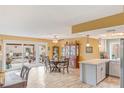 Bright dining area with sliding door to patio, adjacent to kitchen with light countertops at 750 Willow Ave, Henderson, NV 89002