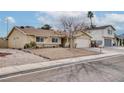 Single story home with a large front yard and mature tree at 750 Willow Ave, Henderson, NV 89002