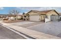 Single-story home with attached garage, driveway, and gated side yard at 750 Willow Ave, Henderson, NV 89002