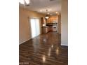 Open kitchen with light wood cabinets and laminate flooring at 8708 Gateway Glen Dr, Las Vegas, NV 89178