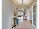 Welcoming foyer with decorative lighting, tile flooring and seamless access to the living spaces at 1595 Cattle Ranch Pl, Henderson, NV 89002