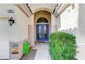 Eye-catching entry featuring a double door with glass inserts and a covered entryway at 1595 Cattle Ranch Pl, Henderson, NV 89002